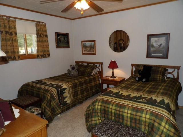 carpeted bedroom featuring ceiling fan and crown molding