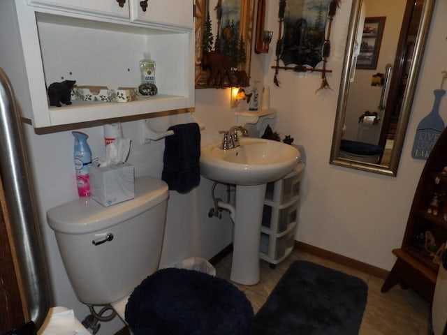 bathroom featuring tile patterned flooring, toilet, and sink