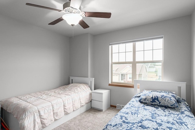 bedroom with light colored carpet and ceiling fan