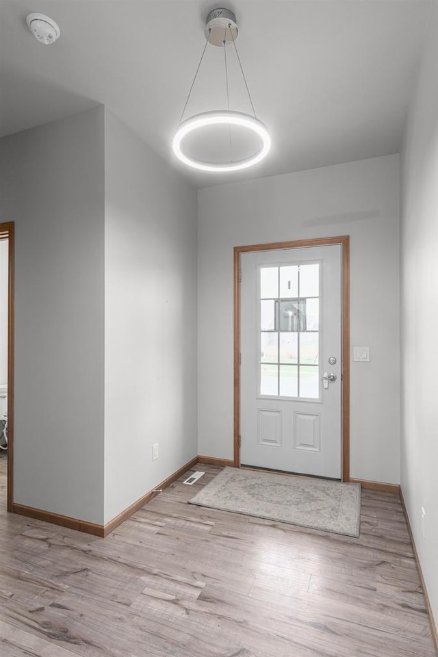 doorway to outside with light hardwood / wood-style floors