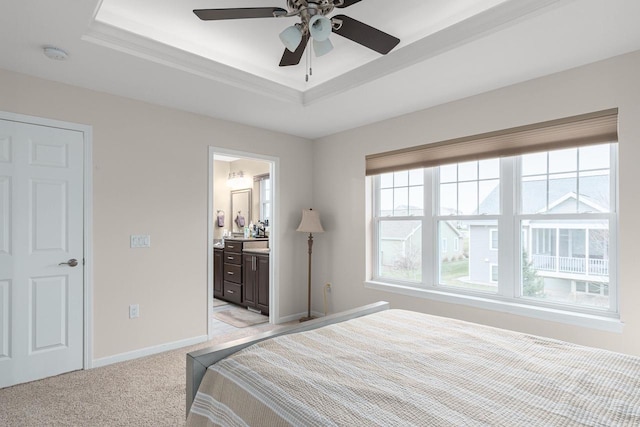 9907 White Fox Ln, Middleton, WI 53562 - bedroom featuring a tray ceiling, light carpet, ensuite bathroom, and ceiling fan