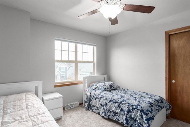 bedroom with ceiling fan and light colored carpet