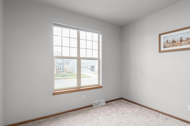 unfurnished room featuring carpet