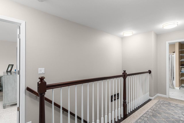 hallway with light colored carpet