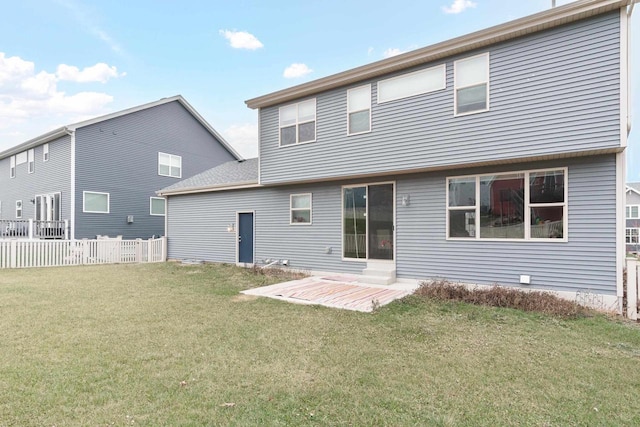 rear view of property featuring a lawn