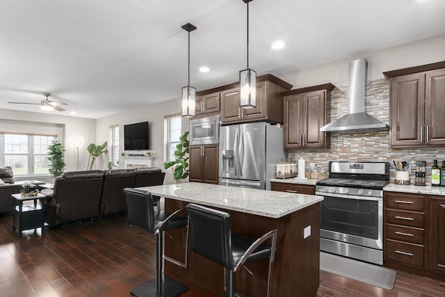 9907 White Fox Ln, Middleton, WI 53562 - kitchen featuring stainless steel appliances, wall chimney exhaust hood, open floor plan, plenty of natural light, and recessed lighting