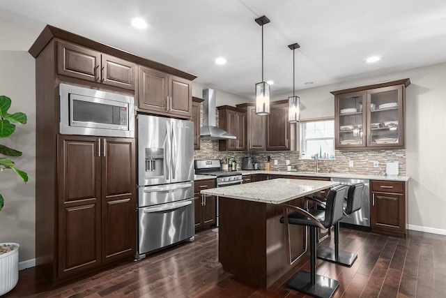 9907 White Fox Ln, Middleton, WI 53562 - kitchen with wall chimney range hood, appliances with stainless steel finishes, dark wood-style floors, backsplash, and dark brown cabinetry