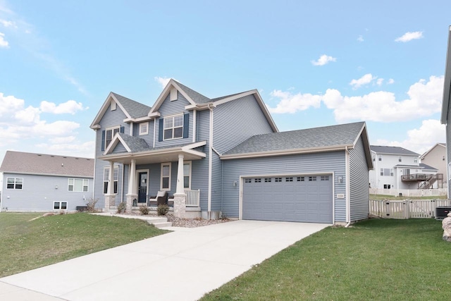 view of front of house featuring a front yard, a porch, and a garage