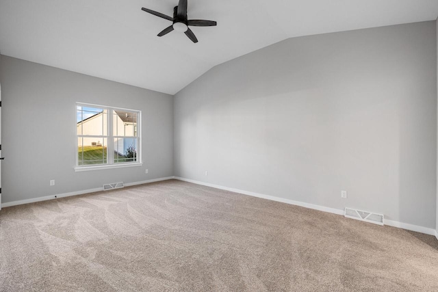 spare room featuring ceiling fan, carpet, and vaulted ceiling