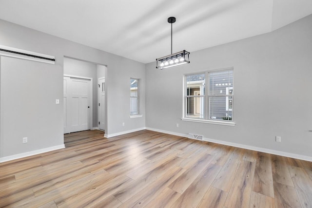 unfurnished dining area featuring light wood-type flooring