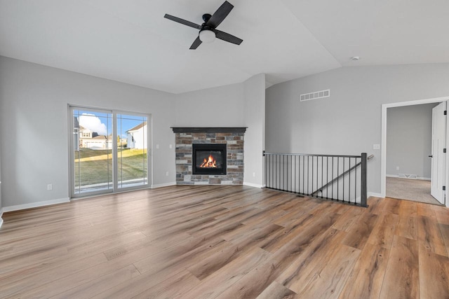 unfurnished living room with a fireplace, light hardwood / wood-style flooring, ceiling fan, and lofted ceiling