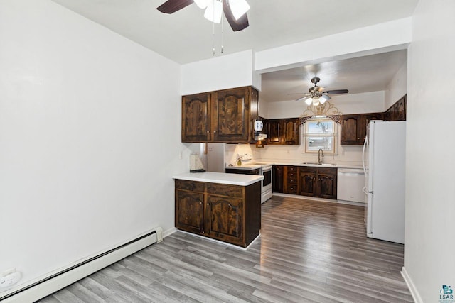 121 E Bayfield St, Washburn, WI 54891 - kitchen featuring white appliances, a baseboard heating unit, sink, light wood-type flooring, and dark brown cabinets