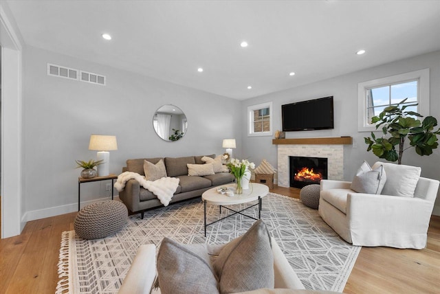 living room featuring a fireplace and hardwood / wood-style floors