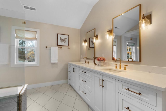 bathroom featuring tile patterned flooring, vanity, and lofted ceiling