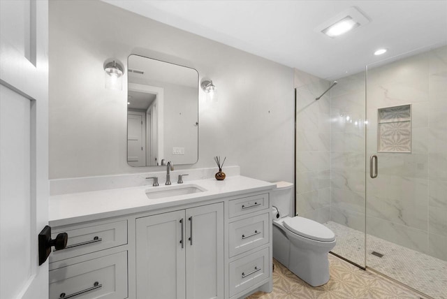 bathroom featuring vanity, toilet, and a shower with door