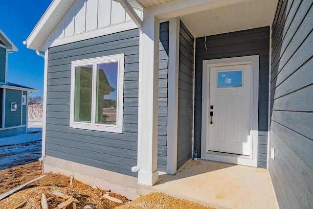 doorway to property featuring board and batten siding