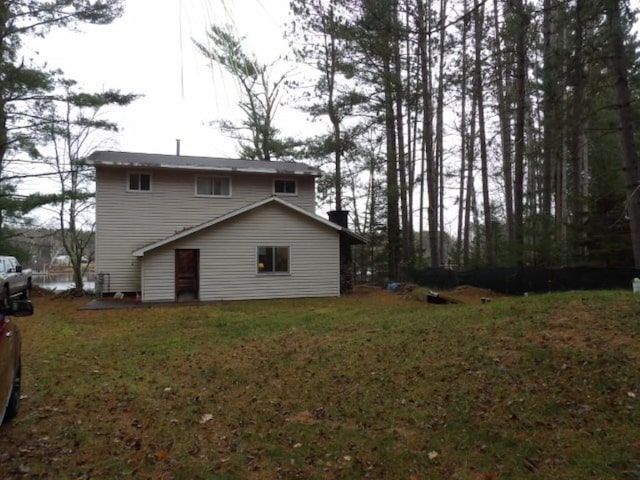 rear view of property featuring a yard