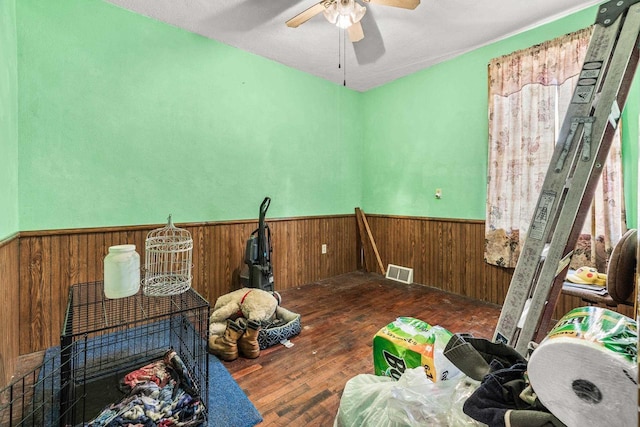 miscellaneous room with ceiling fan and dark wood-type flooring