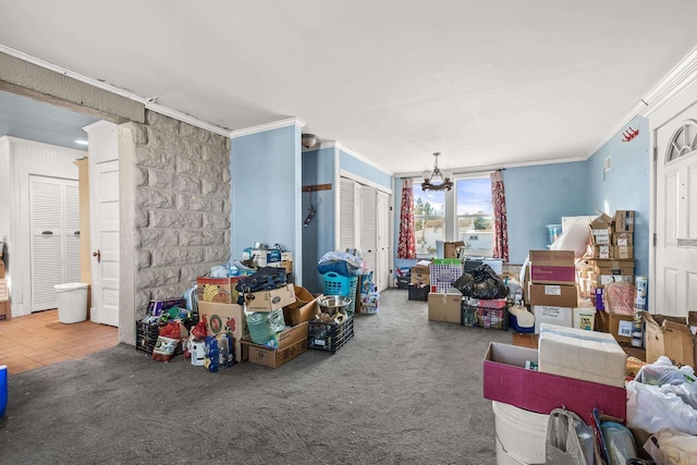 misc room with carpet flooring, crown molding, and an inviting chandelier