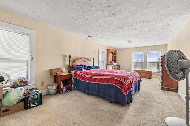 carpeted bedroom featuring a textured ceiling