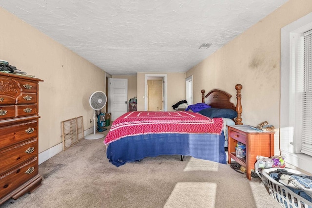 carpeted bedroom featuring a textured ceiling