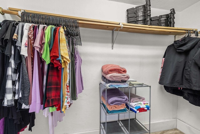 walk in closet with carpet flooring