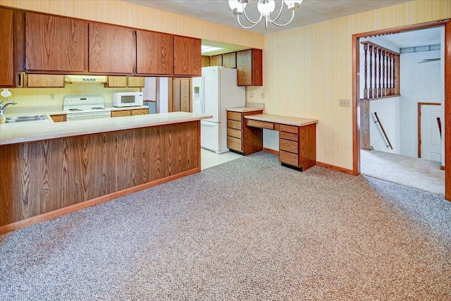 kitchen with kitchen peninsula, light carpet, white appliances, sink, and a notable chandelier