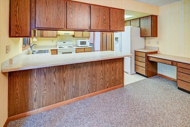 kitchen with kitchen peninsula, white appliances, custom exhaust hood, and sink