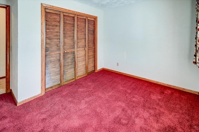 unfurnished bedroom with carpet and a closet