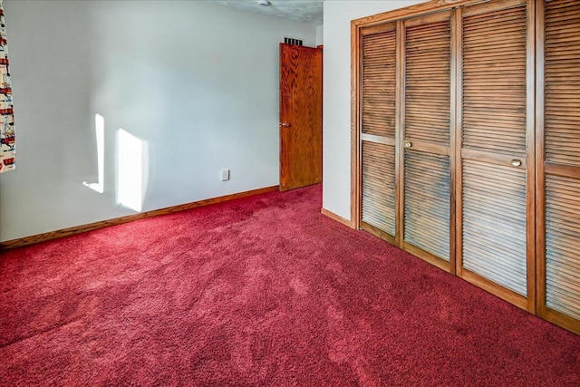 unfurnished bedroom featuring carpet and a closet