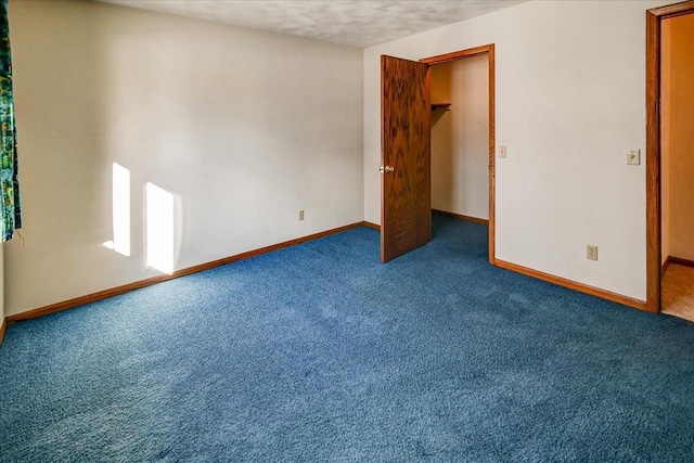 carpeted spare room with a textured ceiling