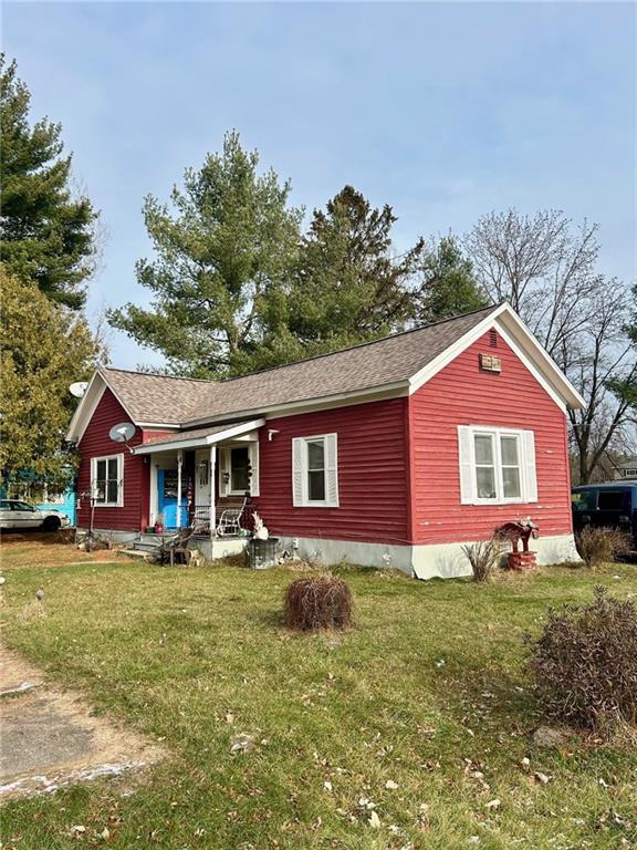 exterior space with a porch and a front lawn