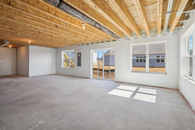 interior space featuring electric panel and a healthy amount of sunlight