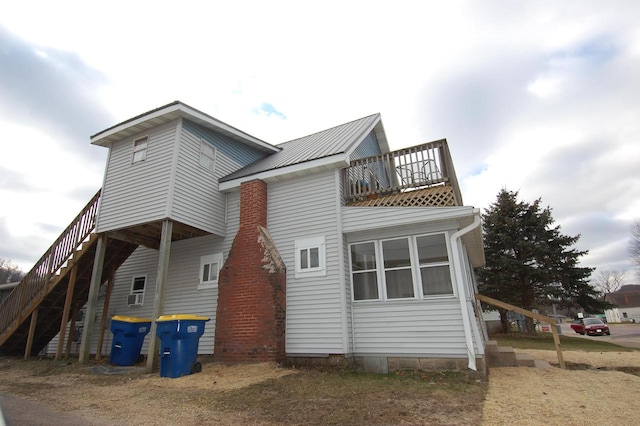 back of house featuring a balcony