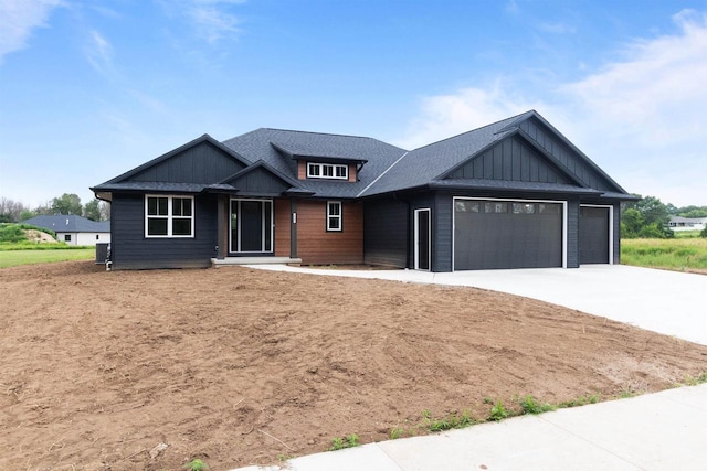 craftsman house with a garage and cooling unit