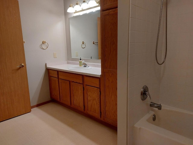 bathroom with vanity and tiled shower / bath combo