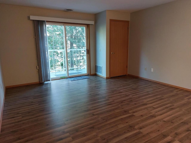 empty room with dark hardwood / wood-style flooring