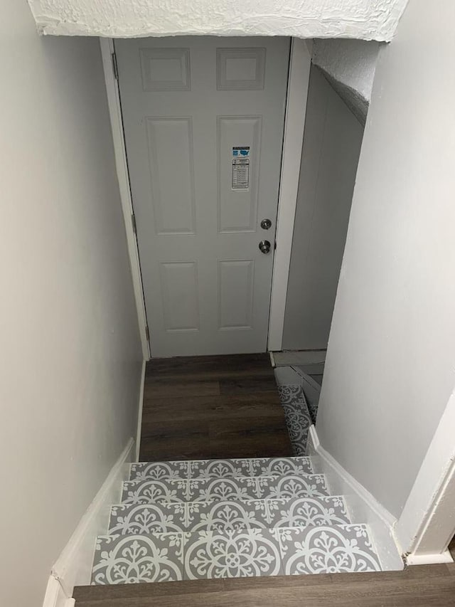 staircase with hardwood / wood-style floors