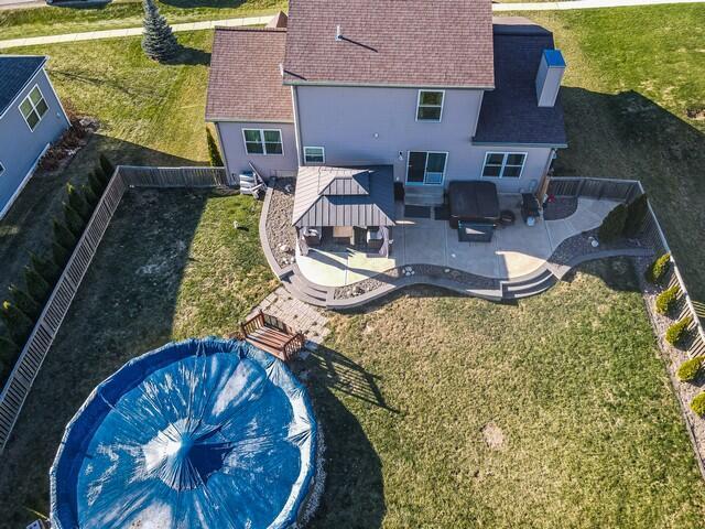 rear view of property featuring a gazebo, a patio area, a yard, and outdoor lounge area