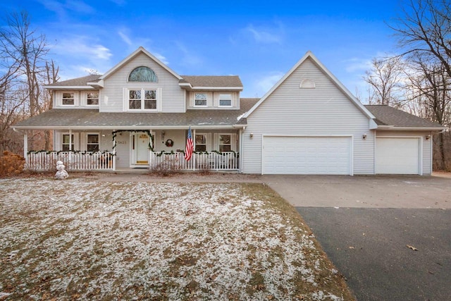 view of front of property featuring covered porch and a garage