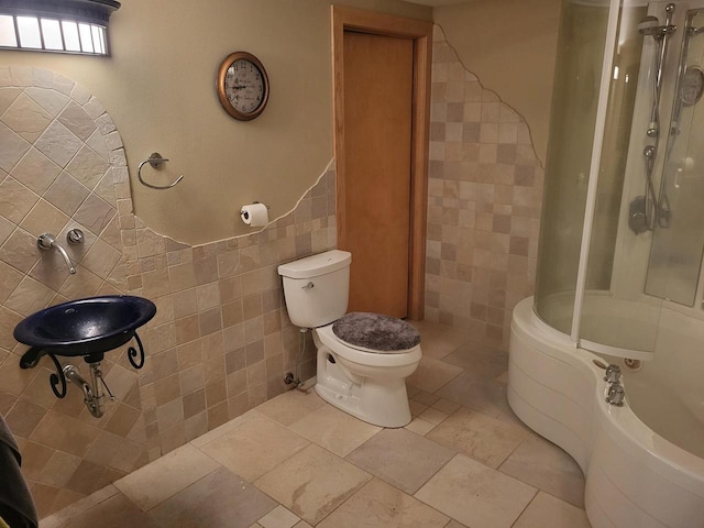 bathroom with  shower combination, tile walls, and toilet