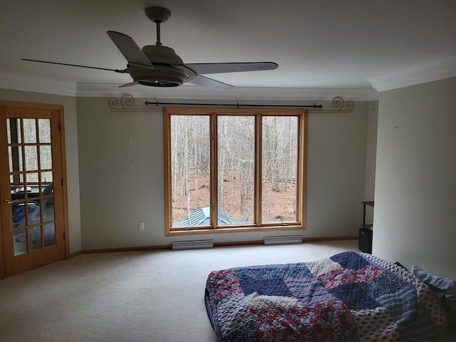 living area with baseboards, carpet, ornamental molding, and a ceiling fan