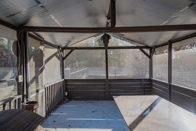 unfurnished sunroom with vaulted ceiling