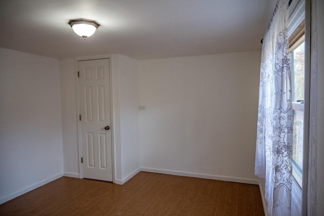 empty room featuring dark wood-type flooring