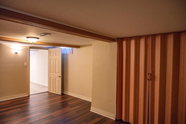 basement with dark hardwood / wood-style flooring