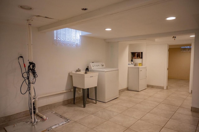 clothes washing area featuring washing machine and clothes dryer and light tile patterned flooring