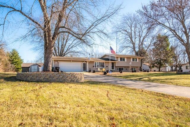 view of front of property featuring a garage and a front lawn