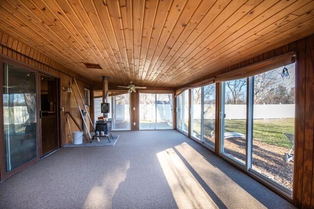 unfurnished sunroom with ceiling fan and wooden ceiling