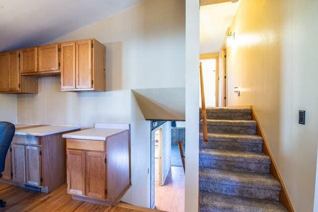 kitchen featuring lofted ceiling and light wood-type flooring