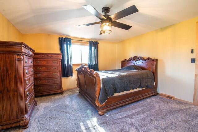 bedroom featuring ceiling fan, carpet floors, and vaulted ceiling